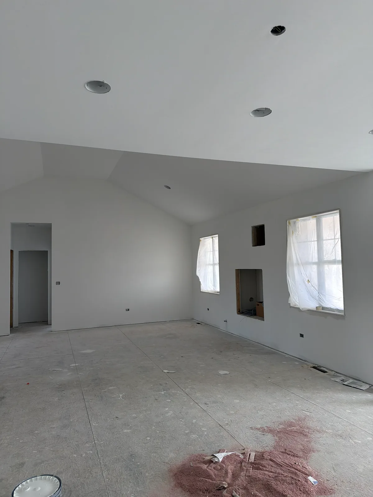 Drywalled rooms ready for finishing during a remodel by EZ Custom Homes