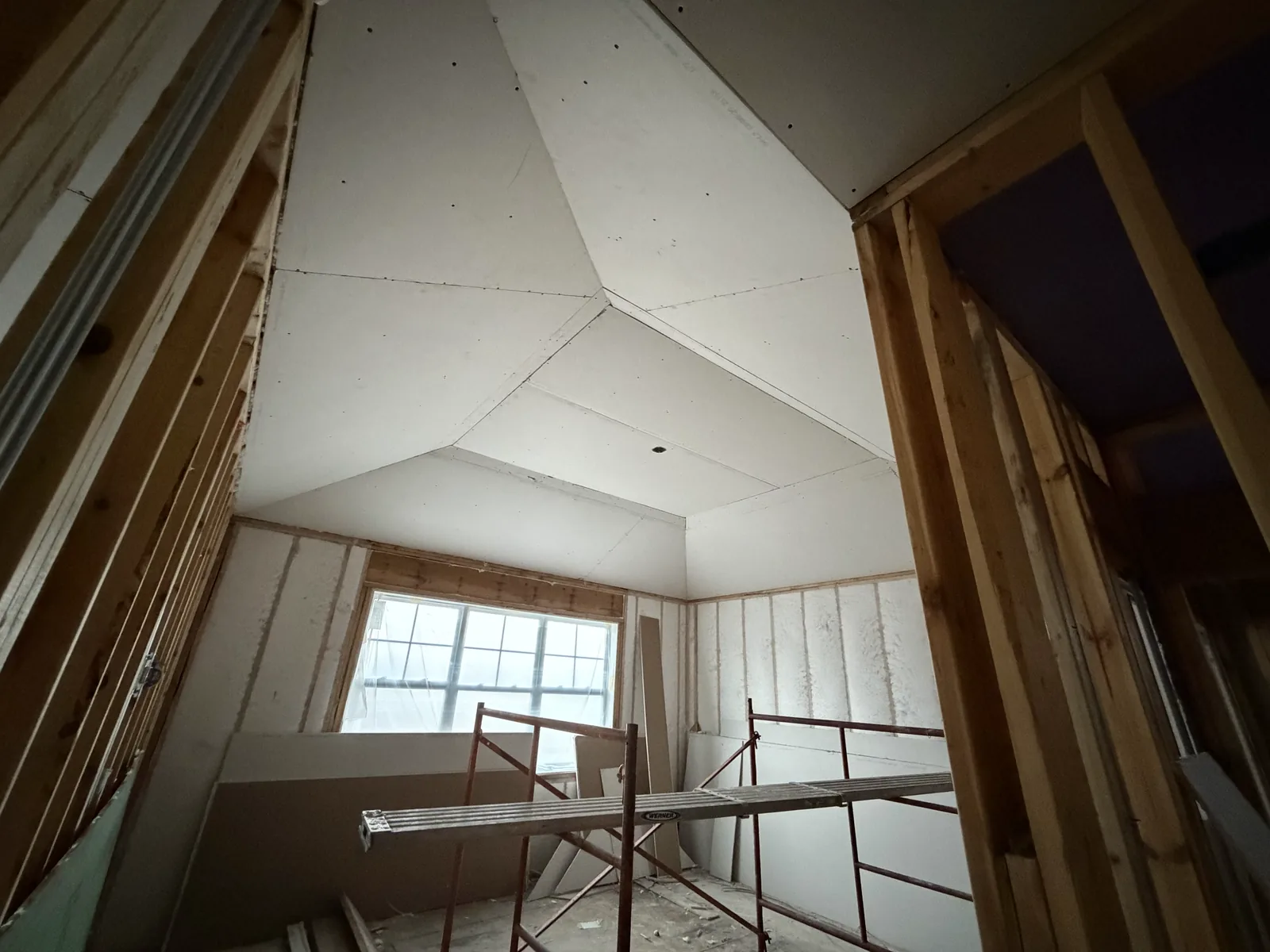 Vaulted upper-floor room drywalled during construction by EZ Custom Homes